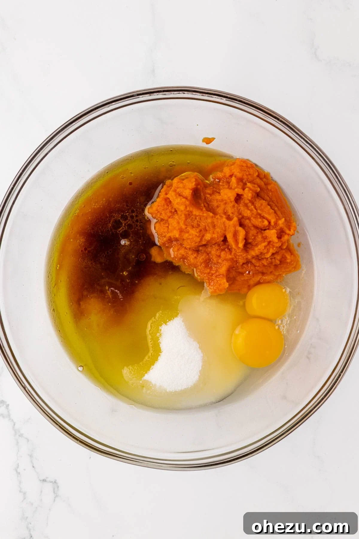 wet ingredients for pumpkin bread gathered in a mixing bowl