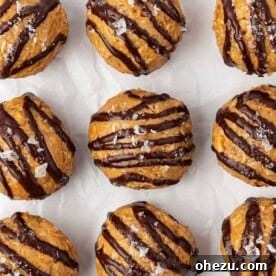 Golden peanut butter energy bites, elegantly drizzled with rich dark chocolate