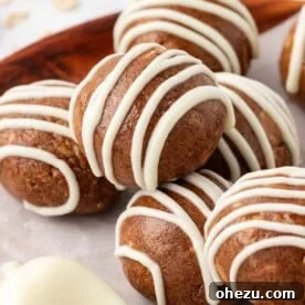 Warm and spicy cinnamon roll energy bites, with visible cinnamon swirls or glaze