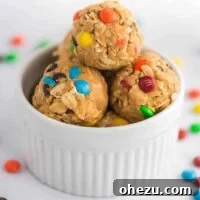 Monster Cookie Energy Balls with colorful mini M&M's visible, alongside oats and peanut butter