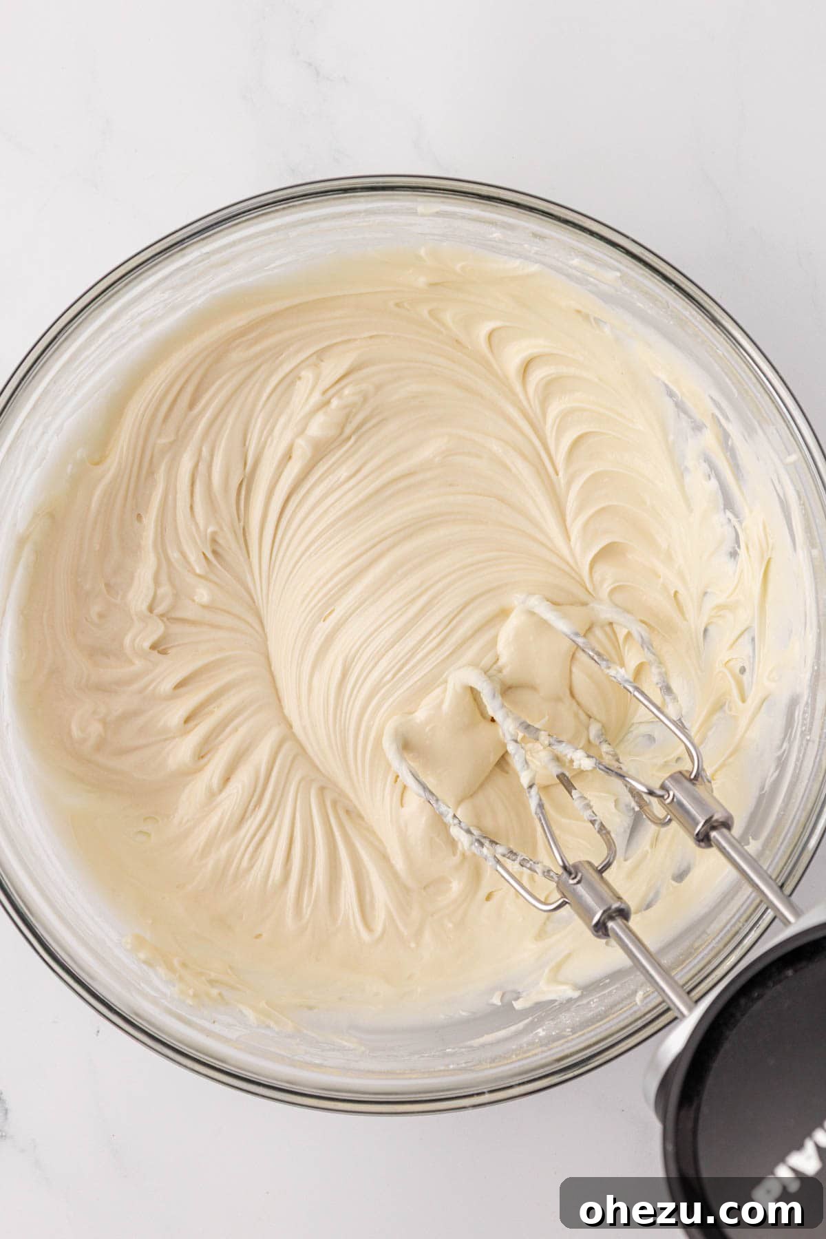Smooth, creamy homemade cream cheese frosting ready in a mixing bowl