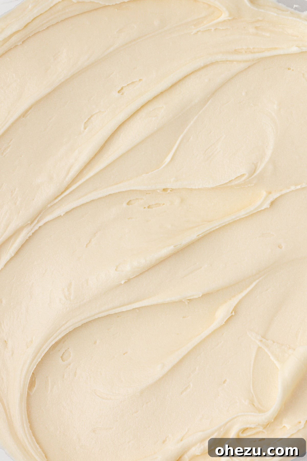 Close-up of perfectly whipped cream cheese frosting, showing its luxurious texture