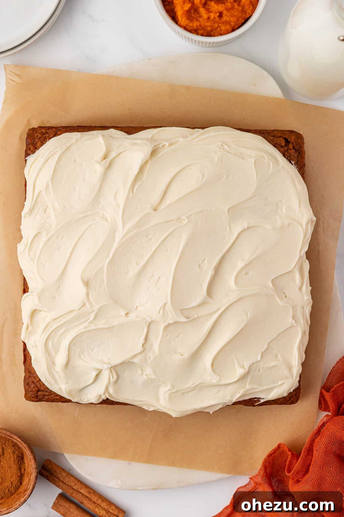 Pumpkin cake beautifully covered with a generous, thick layer of cream cheese frosting