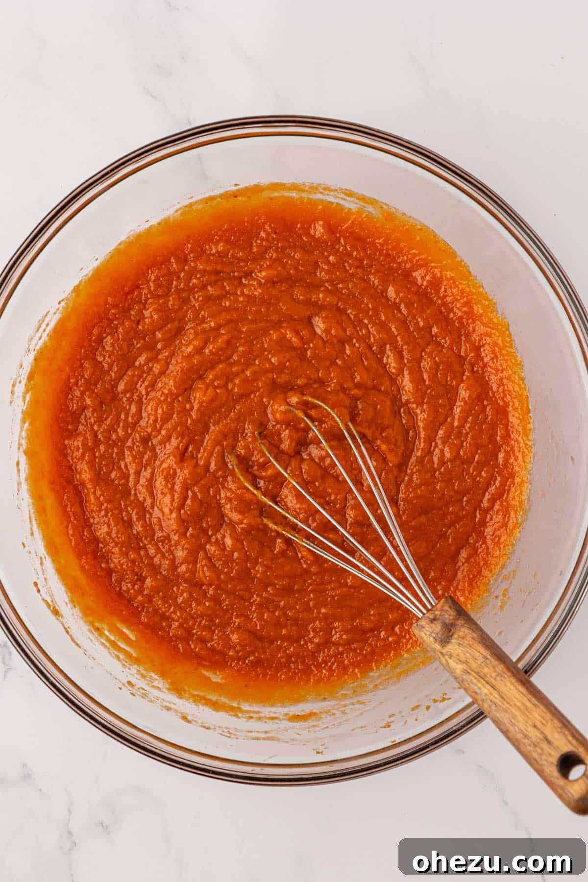 Fully mixed wet ingredients for pumpkin cake, smooth and vibrant