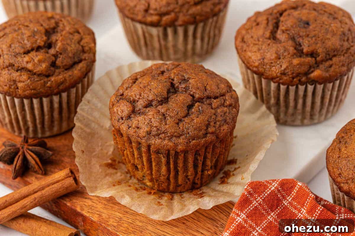 Single pumpkin banana muffin on a rustic wooden surface