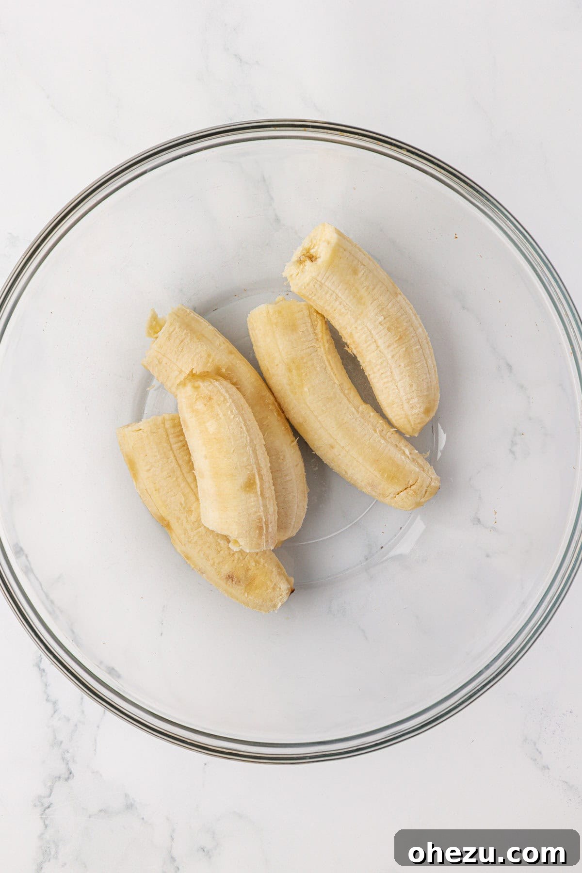 Whole ripe bananas in a mixing bowl before mashing