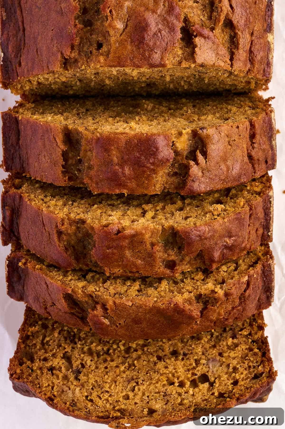 Warm slices of pumpkin banana bread arranged on a wire rack to cool, showcasing their tender texture