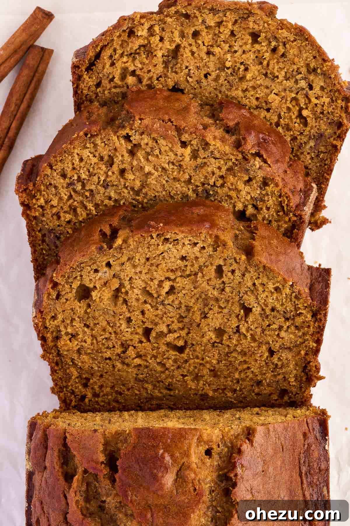 Artfully arranged slices of pumpkin banana bread on a serving board, garnished for presentation