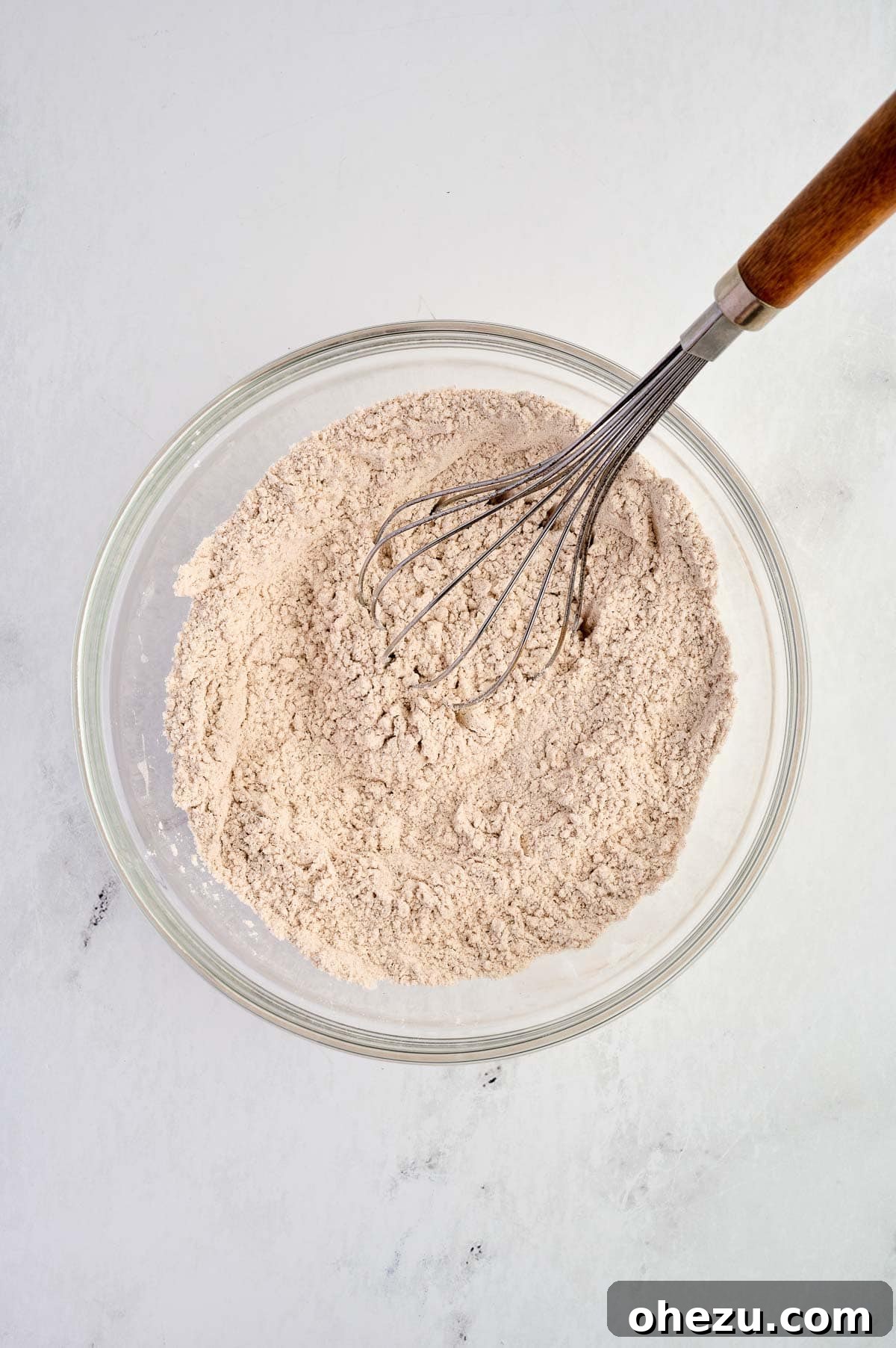 Dry ingredients thoroughly whisked together in a bowl, creating a light, uniform, and well-aerated mixture