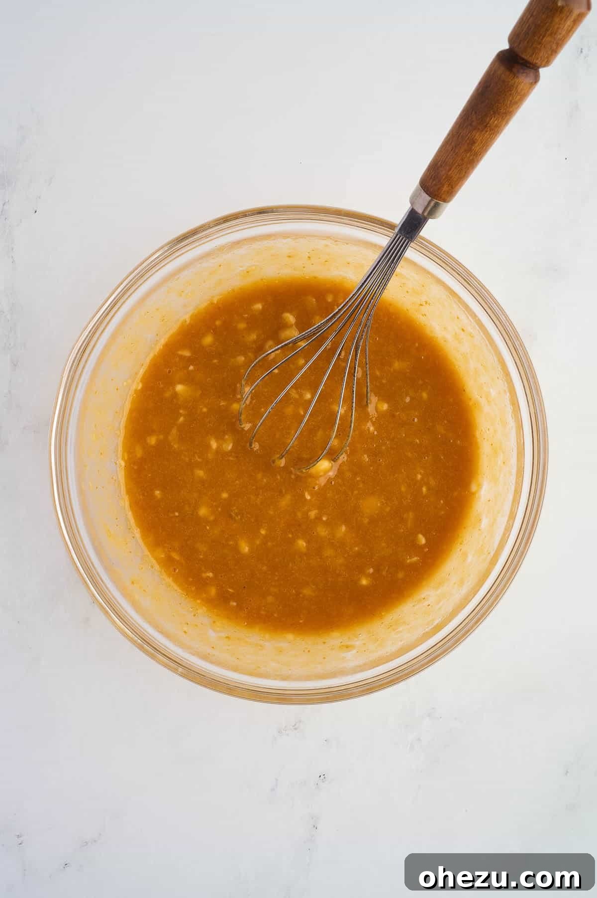 Wet ingredients thoroughly whisked until smooth, glossy, and fully combined, ready for the dry mixture