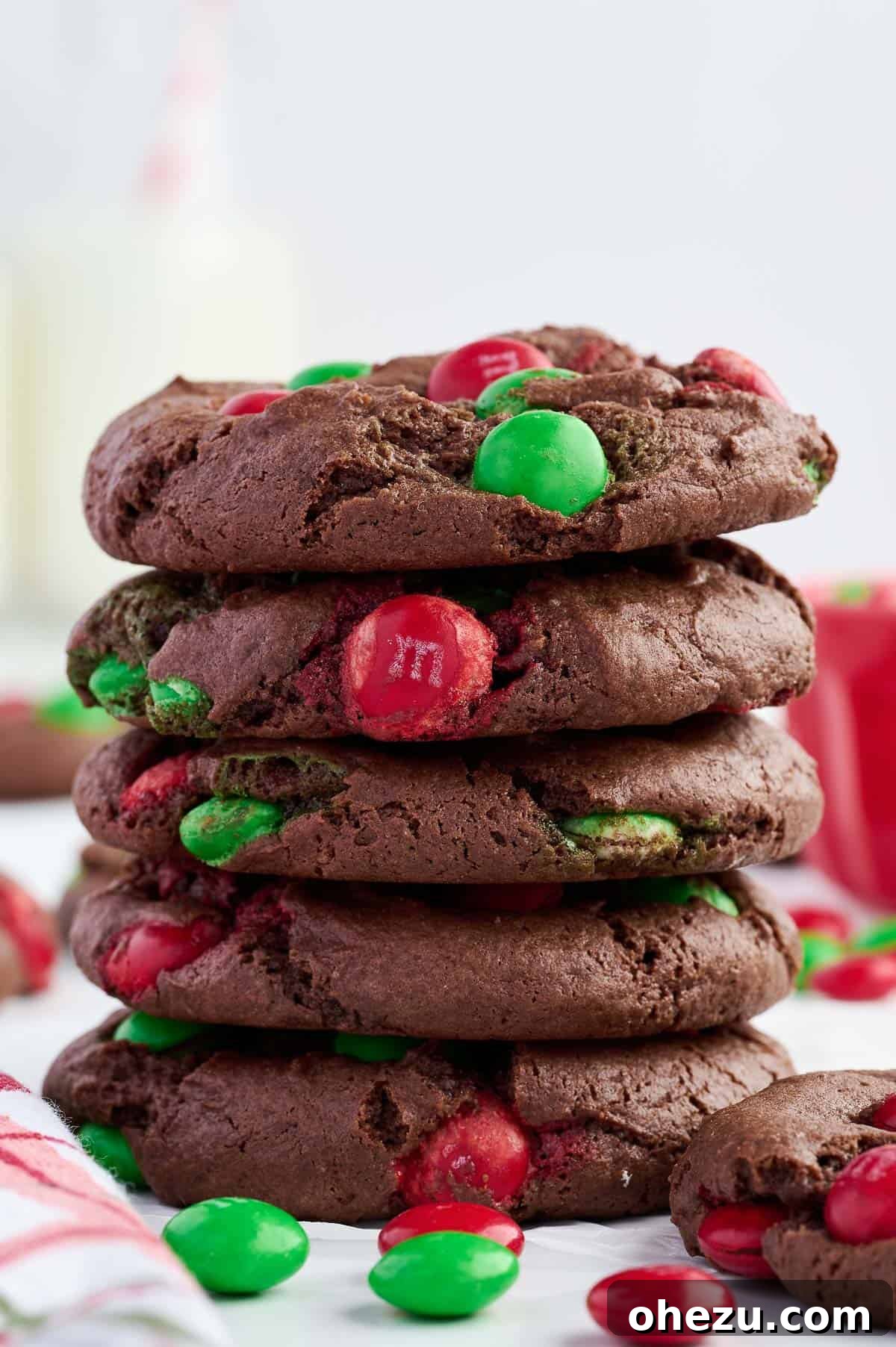 stack of chocolate Christmas cookies showing off their fudgy texture and colorful M&M's