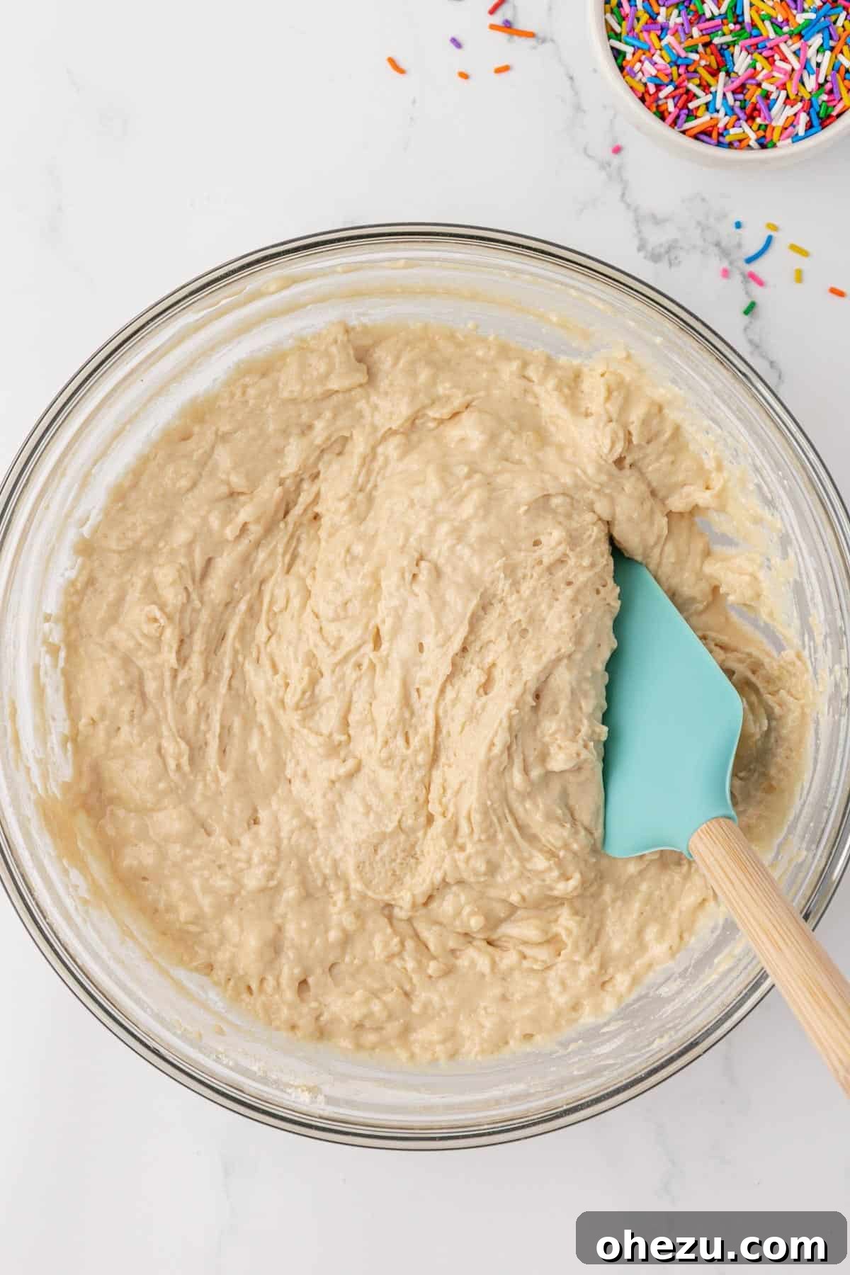 Mixing dry and wet ingredients until just combined for muffin batter