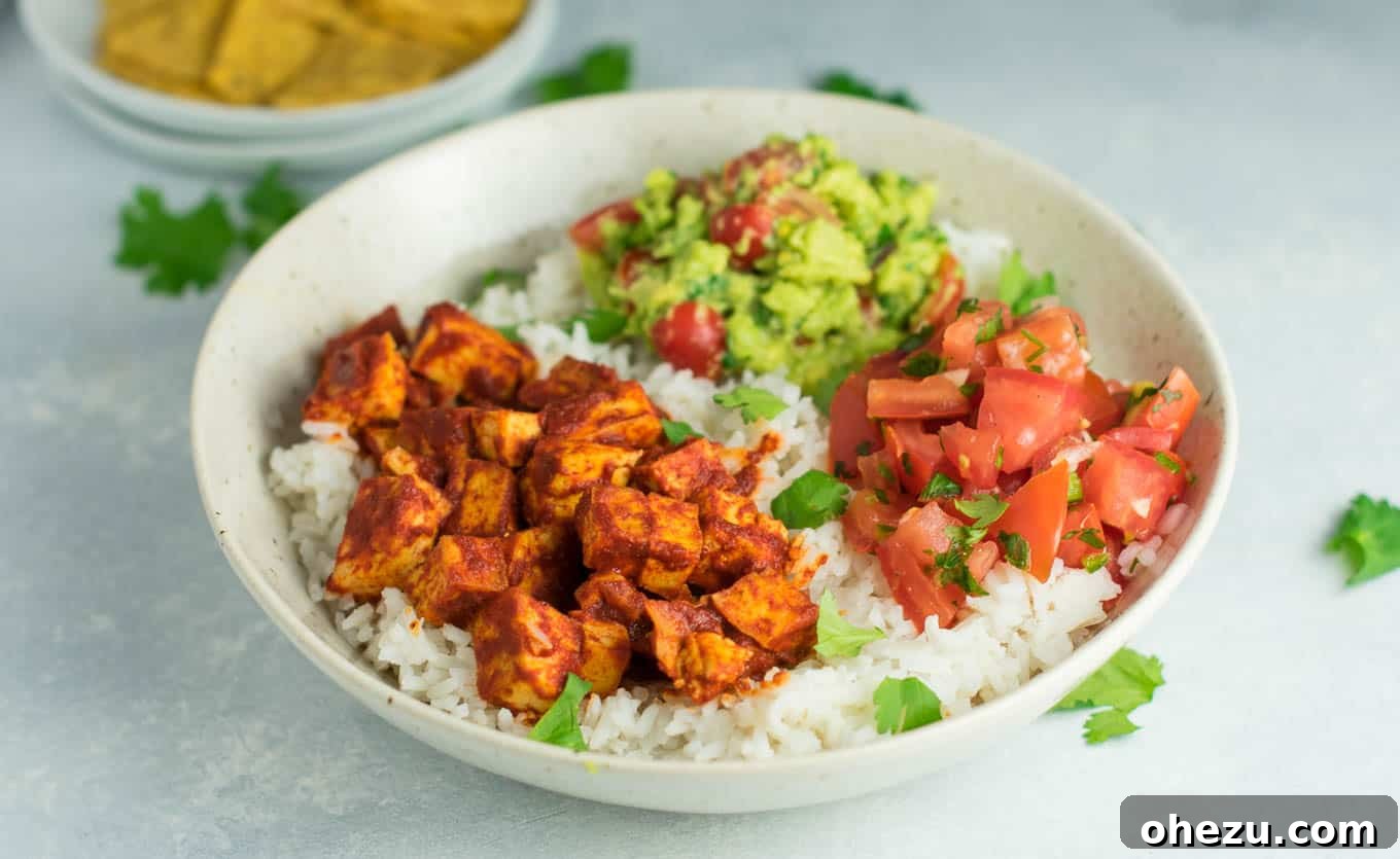 Quick Fiesta Tofu Burrito Bowls 9 Two vibrant and appetizing enchilada tofu burrito bowls, arranged on a surface.