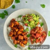 Easy enchilada tofu burrito bowls with homemade guacamole and salsa.
