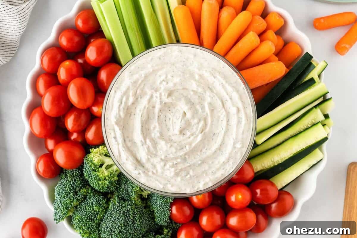 A vibrant bowl of homemade veggie dip, beautifully arranged with a colorful assortment of fresh vegetables for dipping.