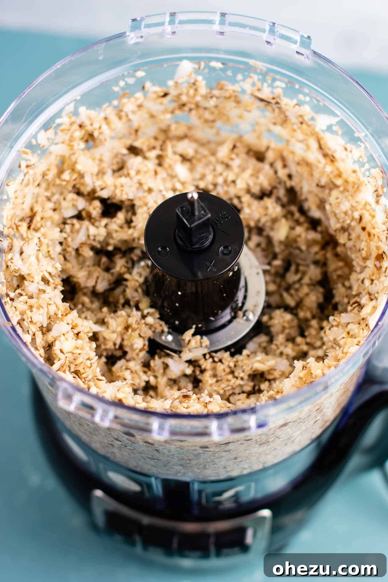 Close-up of finely minced mushrooms, onions, and garlic in a food processor, prepared for the savory base of lasagna soup.