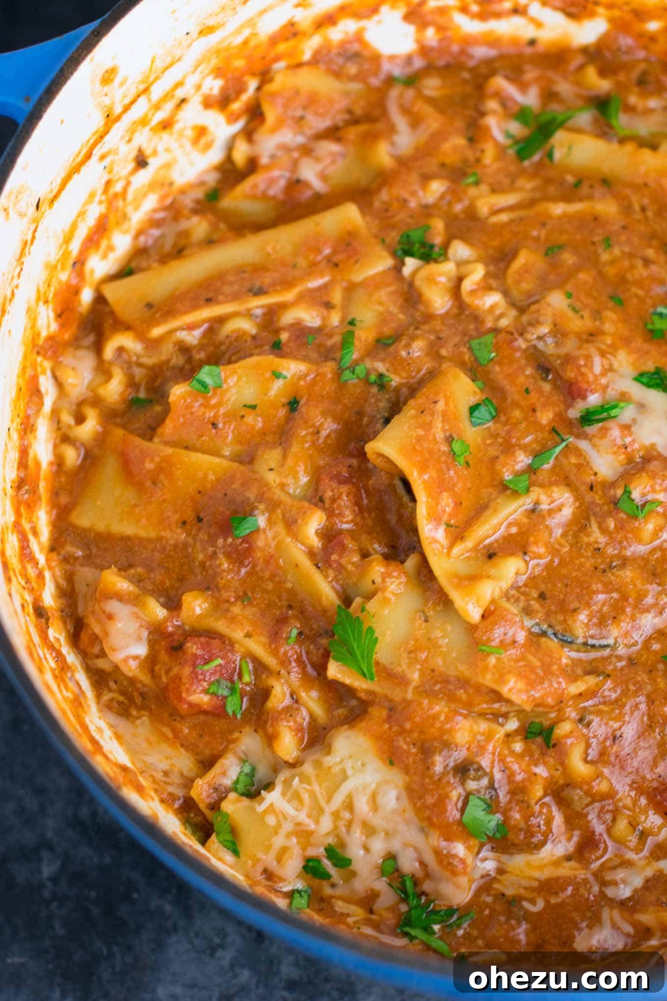 Broken lasagna noodles simmering in a rich, bubbling tomato broth in a single pot, cooking to perfection for an easy vegetarian lasagna soup.