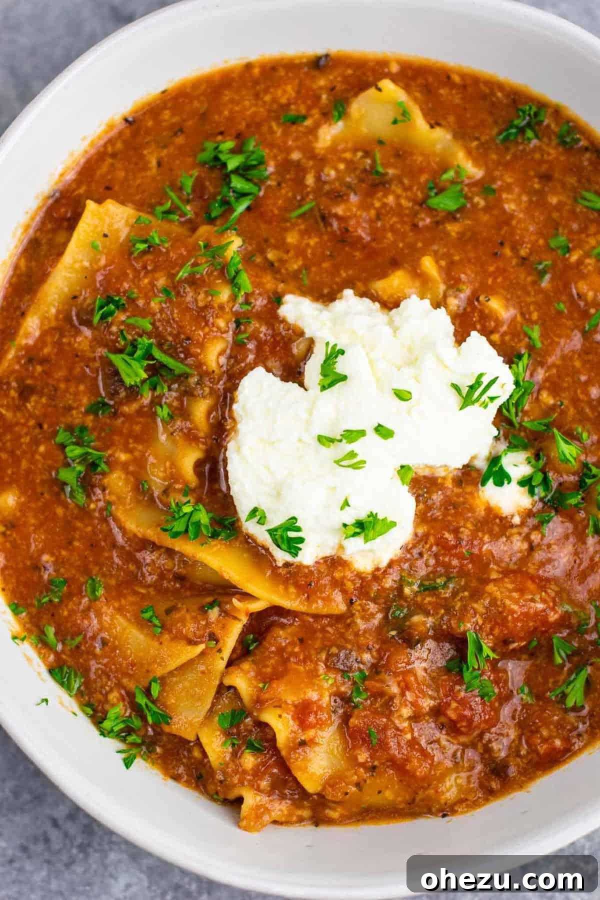 Two bowls of delicious vegetarian one-pot lasagna soup on a table, perfectly garnished and ready to eat, showcasing a satisfying weeknight meal.
