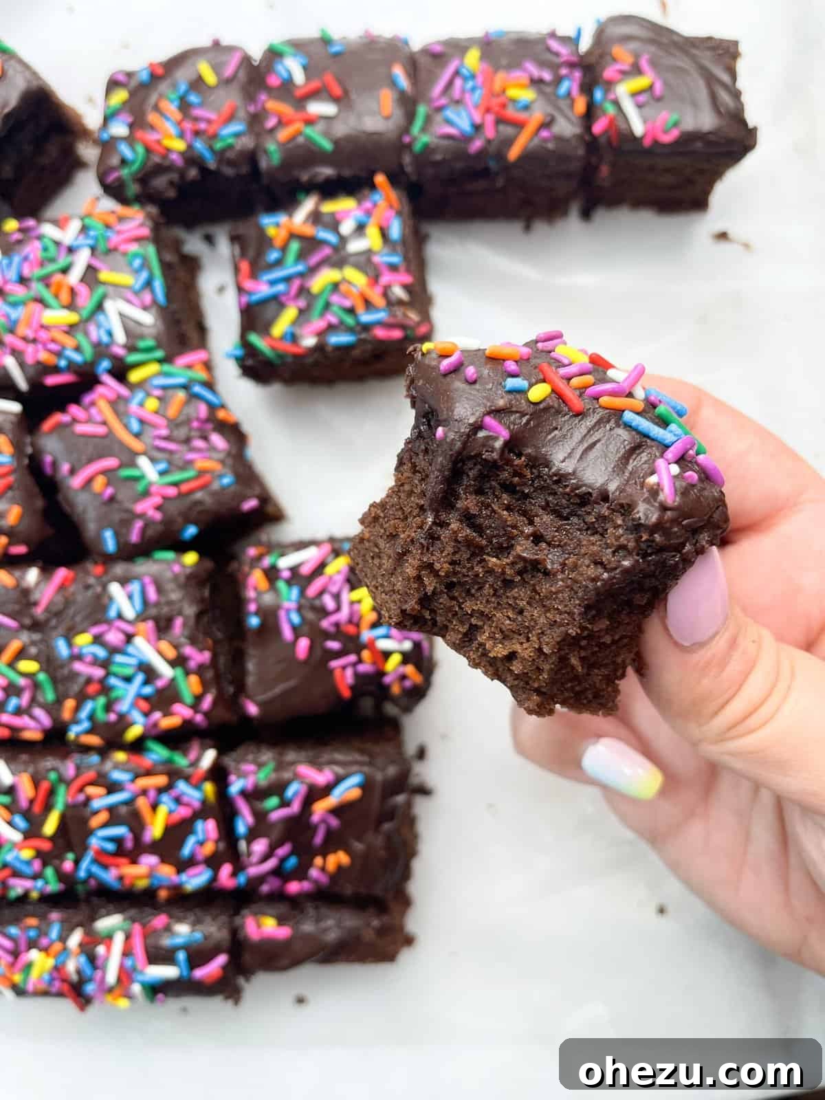 Decadent Chocolate Donut Cakelets 5 A cutting board filled with freshly made Chocolate Donut-Frosted Cake Bites, ready to be served.