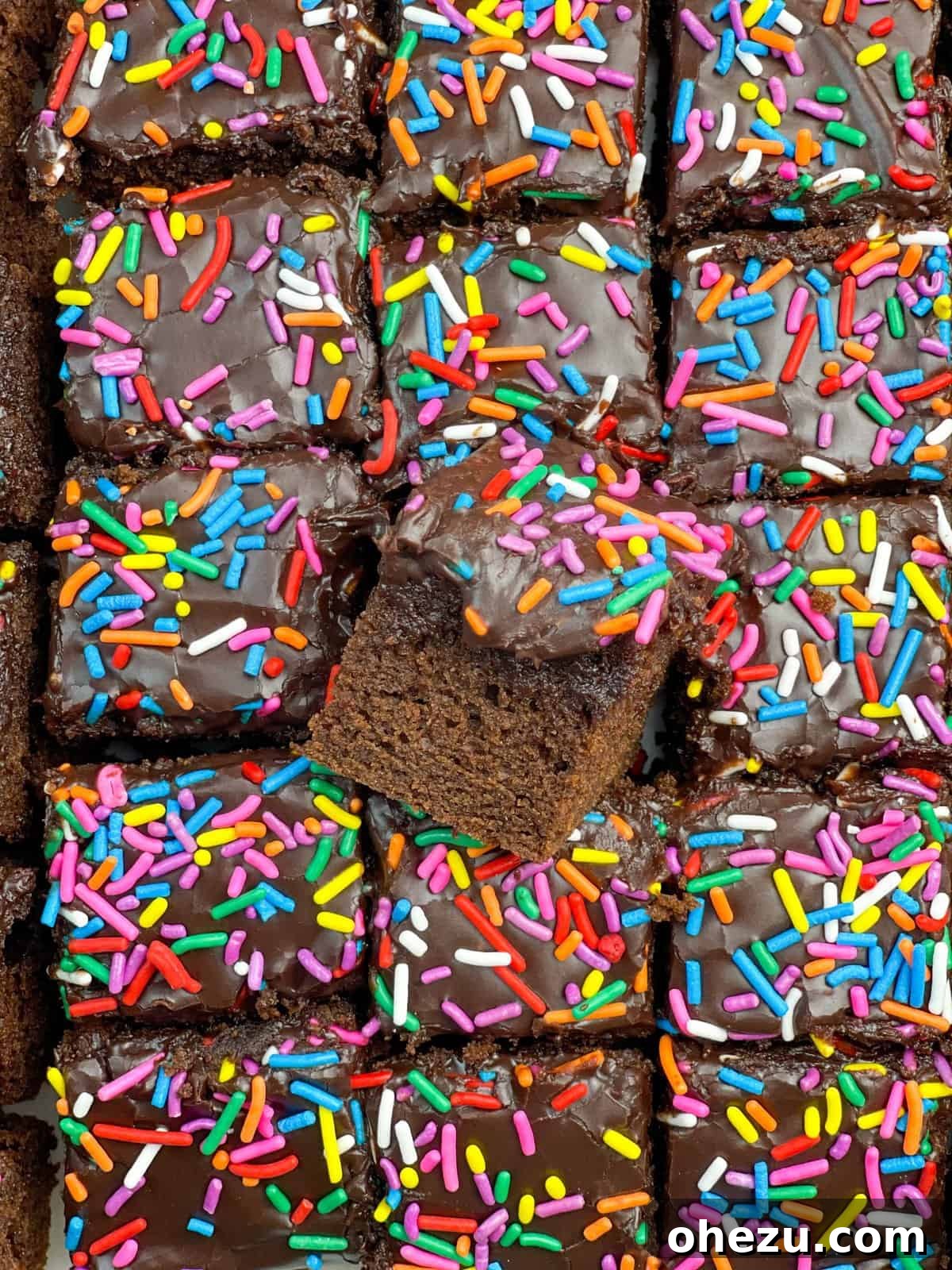 Decadent Chocolate Donut Cakelets 6 A beautifully arranged stack of Chocolate Donut-Frosted Cake Bites on a rustic wooden board, ready for serving.