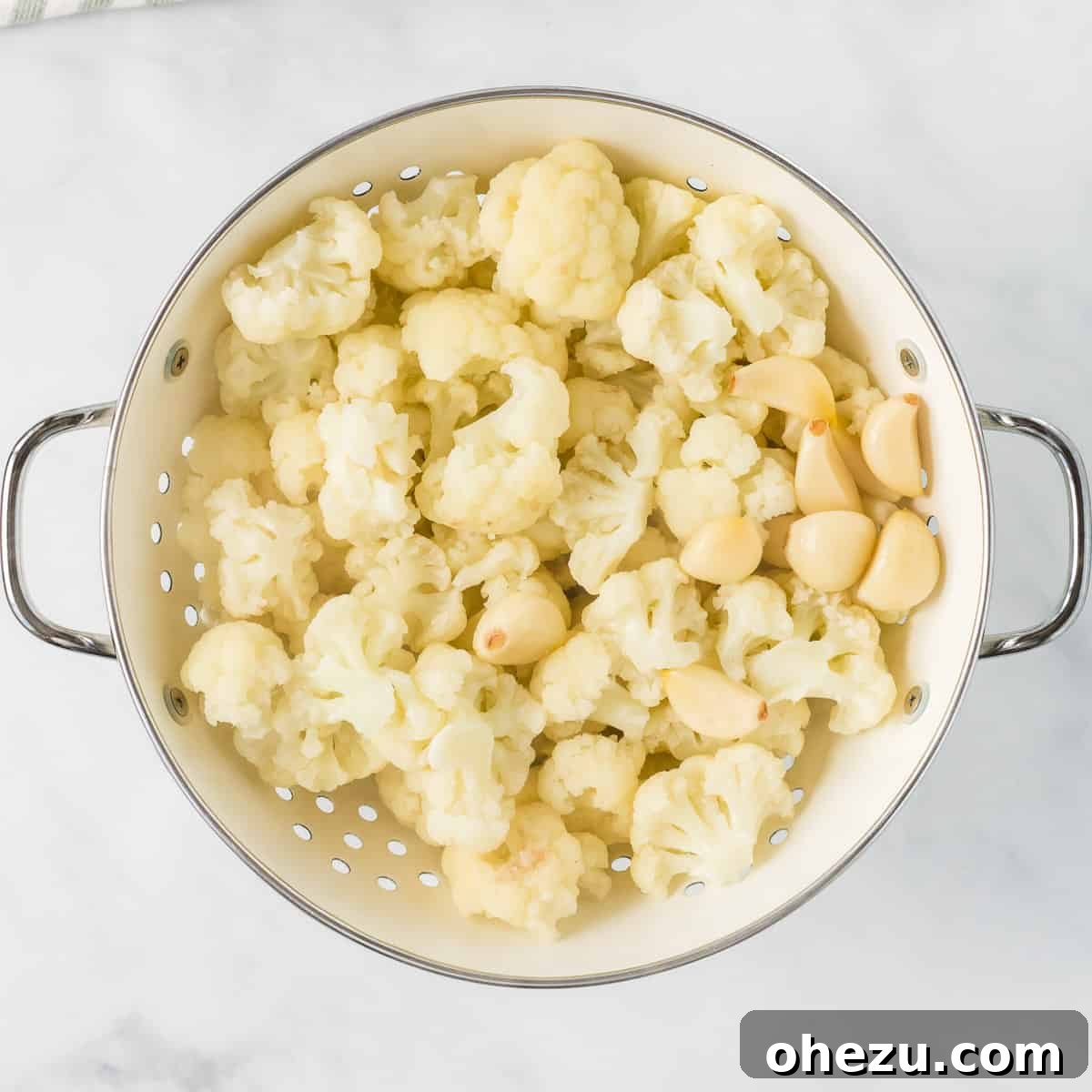 steamed cauliflower and garlic in a strainer
