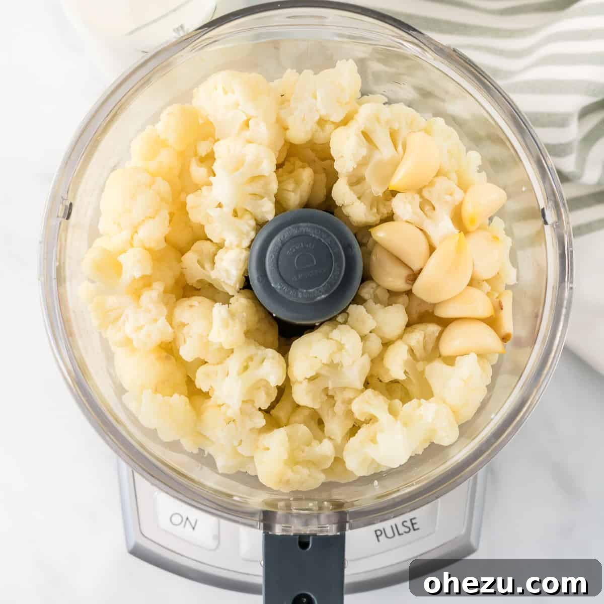 steamed cauliflower and garlic in a food processor