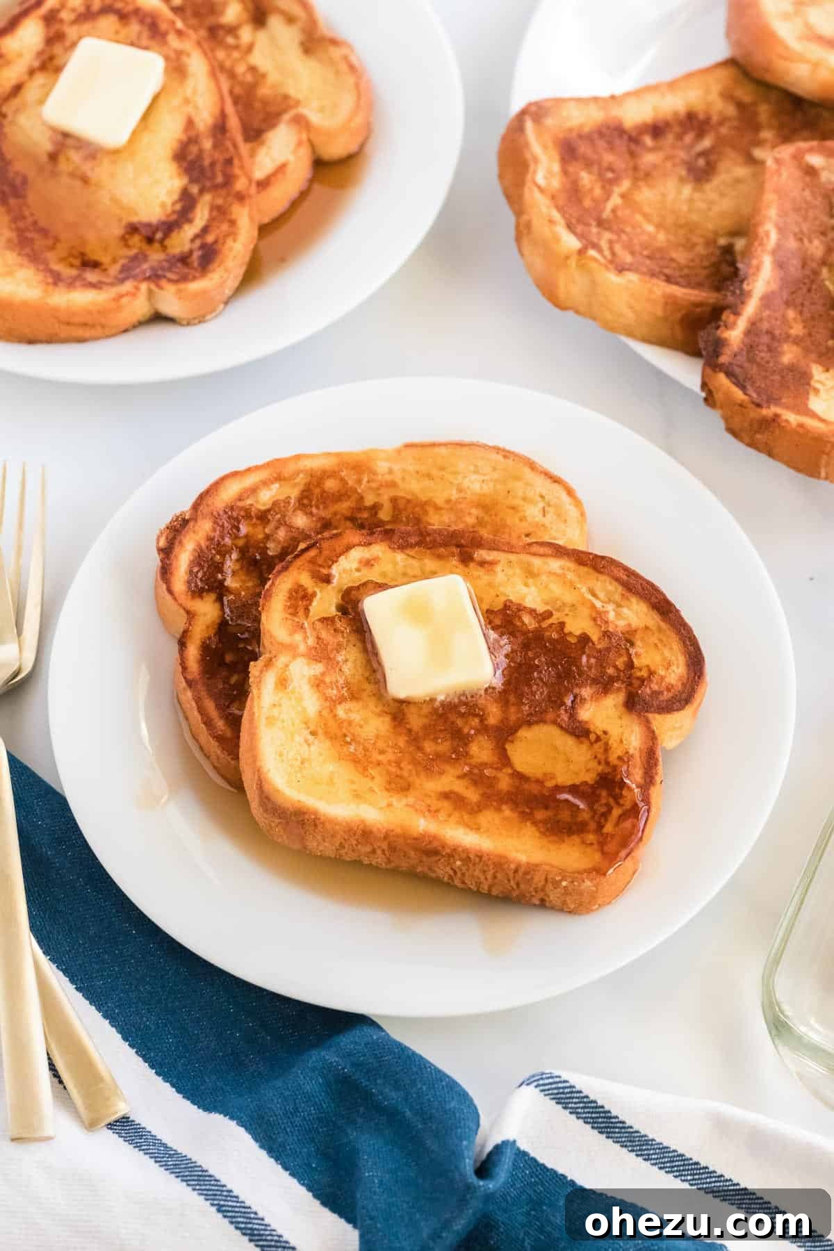 Festive Eggnog French Toast 9 A final close-up of a stack of golden eggnog French toast, glistening with warm maple syrup and a melting pat of butter, highlighting its perfectly cooked texture and inviting warmth.