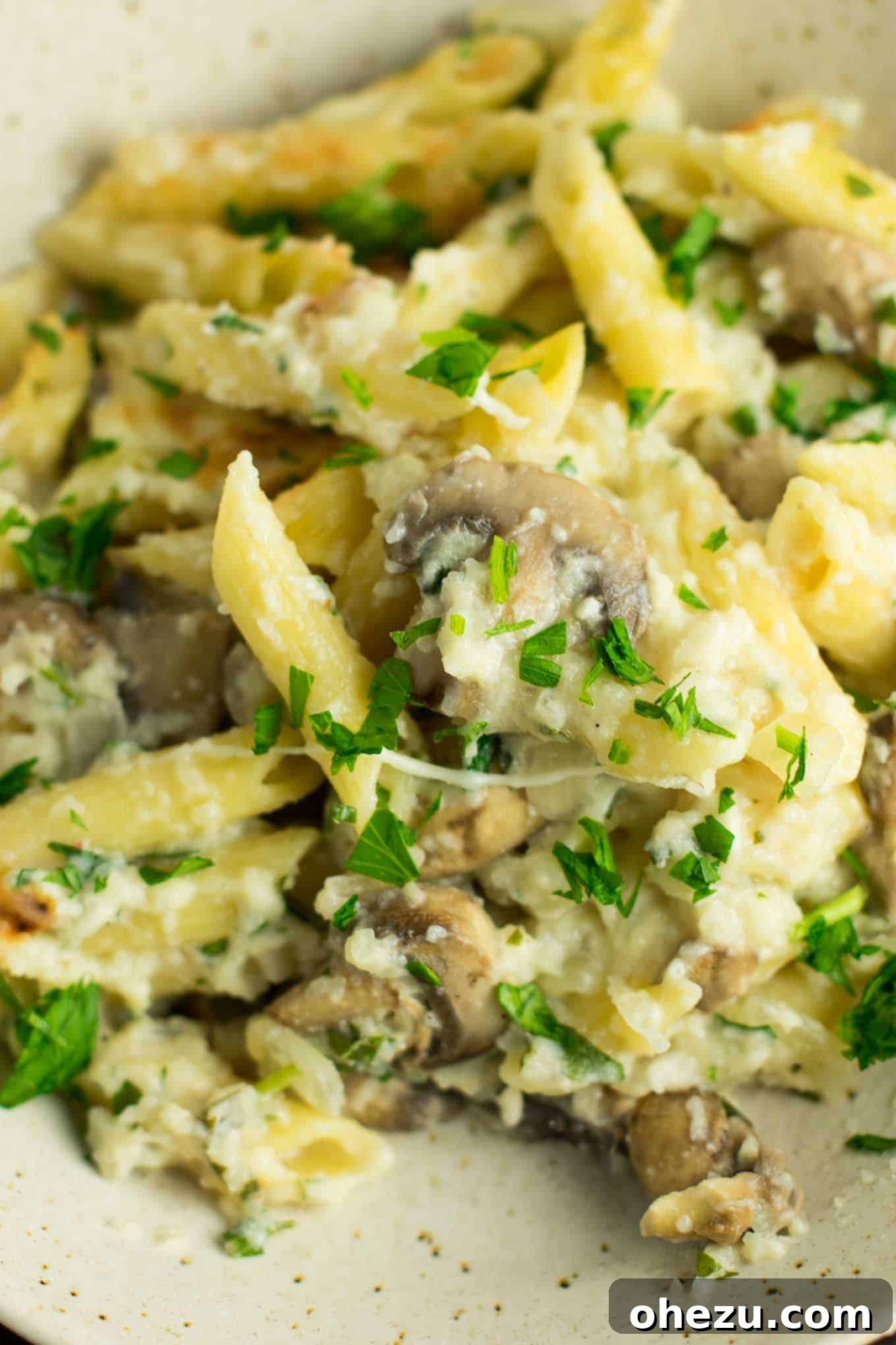 Creamy Mushroom & Cauliflower Alfredo Pasta Bake 7 Close-up of fresh parsley being chopped for the pasta bake