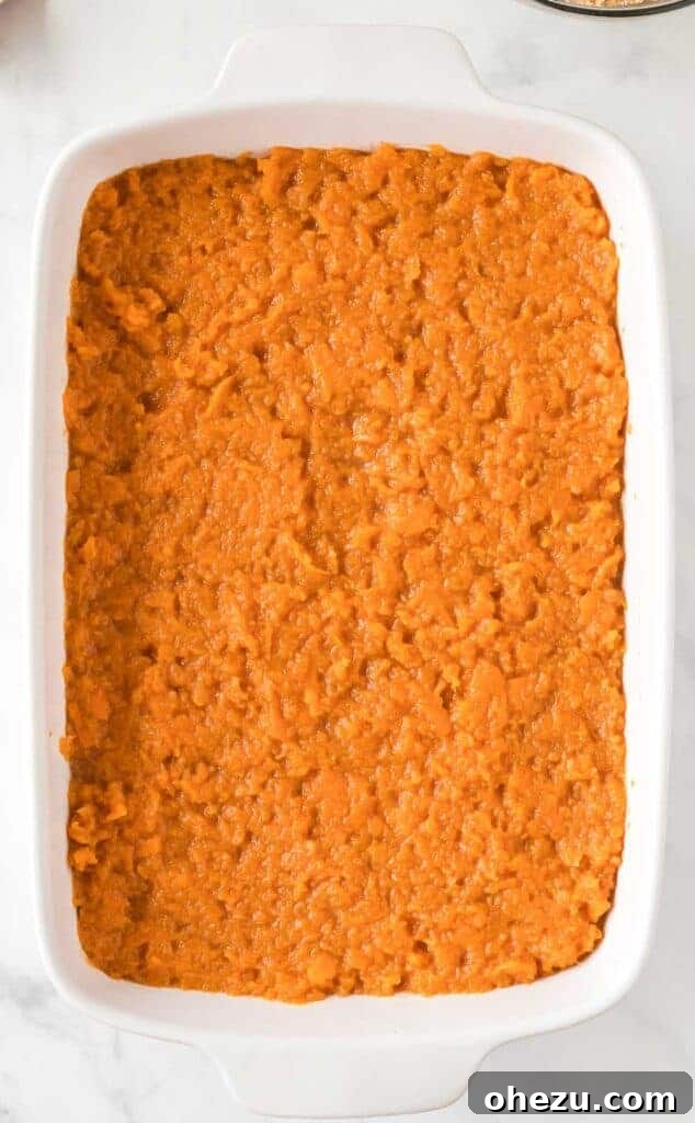 Golden Gluten-Free Sweet Potato Bake 11 Smooth sweet potato filling spread evenly in a glass casserole dish