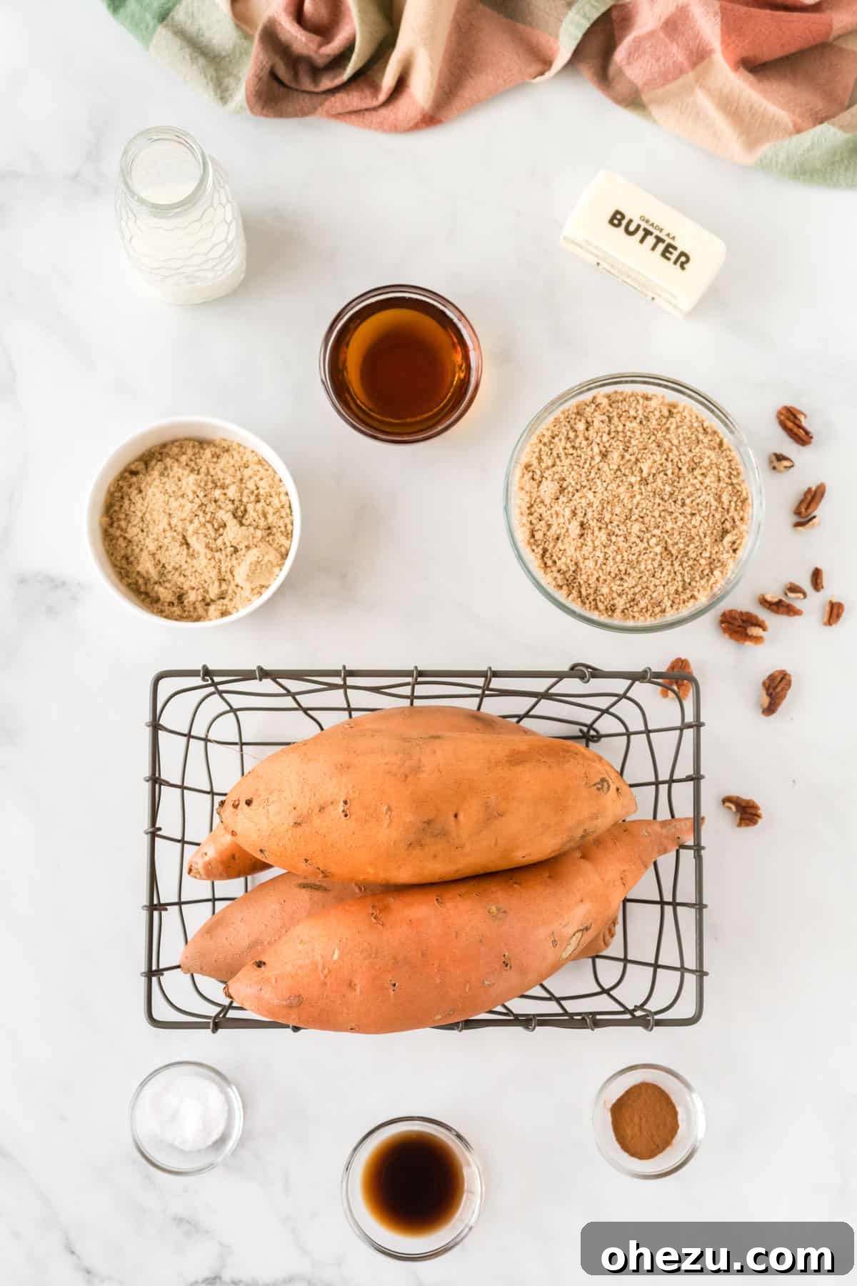 Golden Gluten-Free Sweet Potato Bake 3 Essential ingredients laid out for making the sweet potato casserole, including fresh sweet potatoes, butter, milk, and pecans