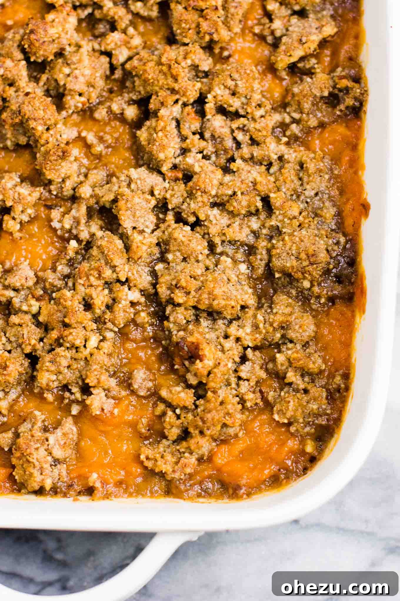 Golden Gluten-Free Sweet Potato Bake 4 Close-up of baked gluten-free sweet potato casserole with a golden, crumbly pecan topping