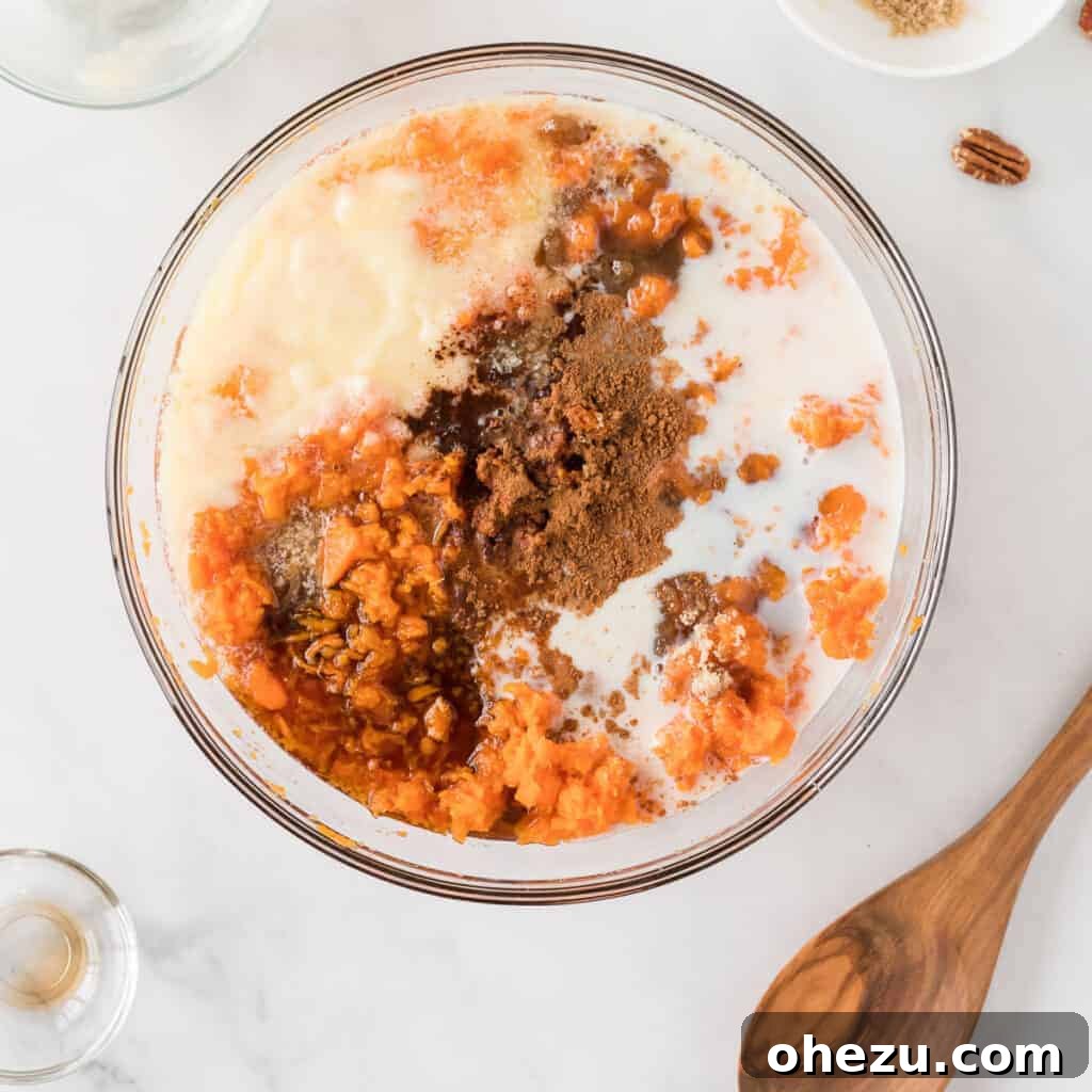 Golden Gluten-Free Sweet Potato Bake 7 All ingredients for the sweet potato filling, including mashed sweet potatoes, butter, and spices, in a mixing bowl