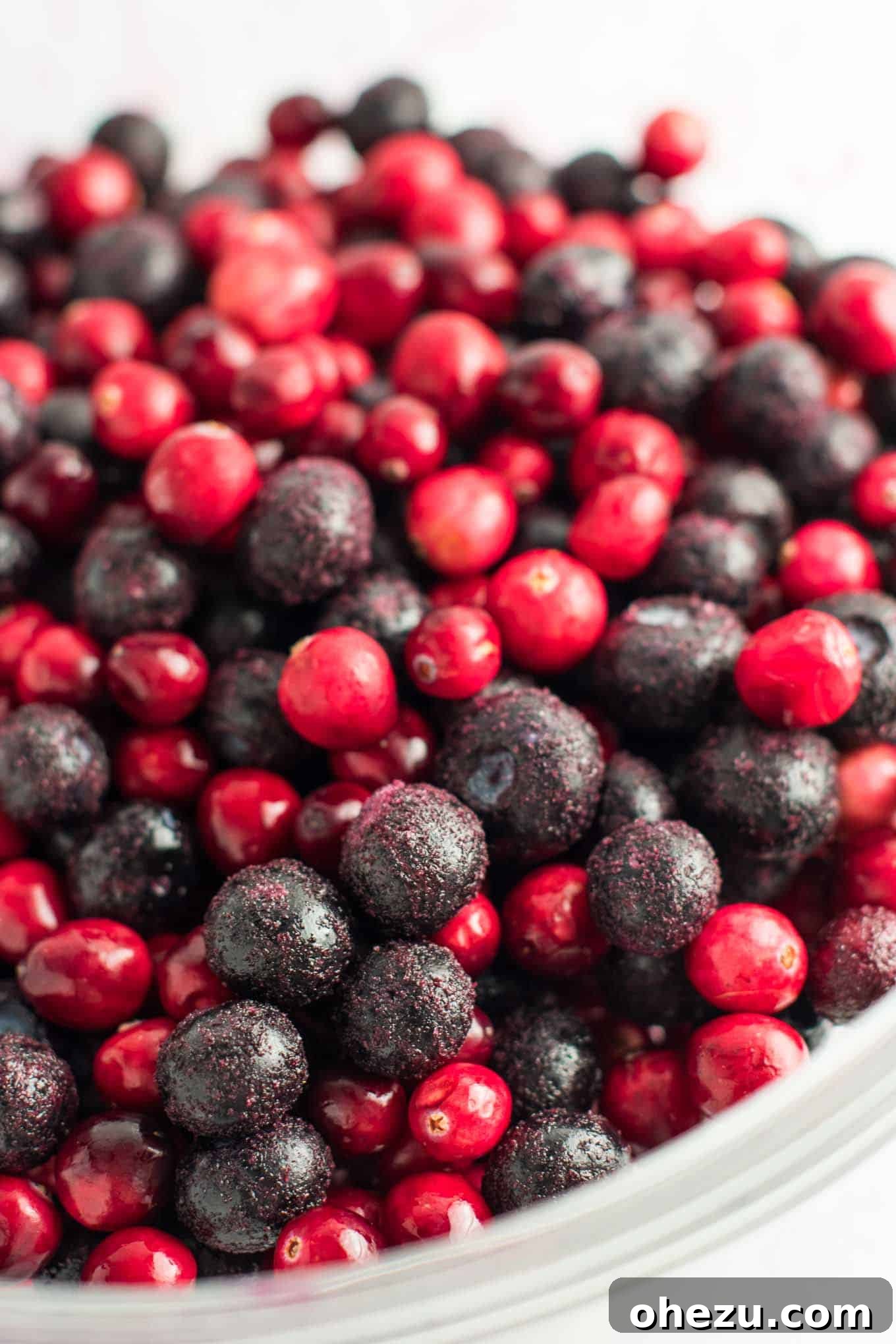 Close-up of frozen blueberries and fresh cranberries mixed together in a bowl, ready for the crisp filling.