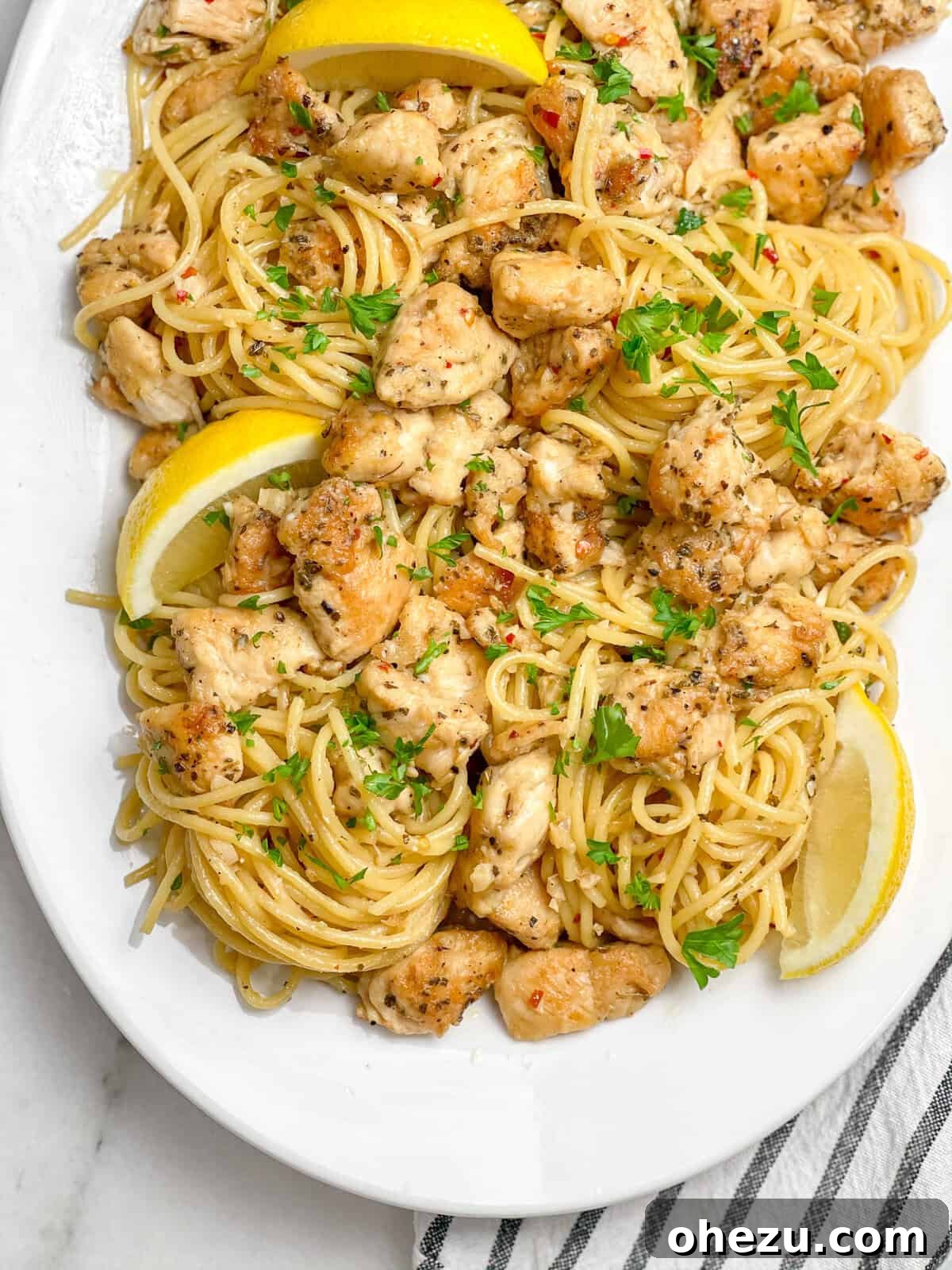 The Ultimate Homemade Chicken Scampi 5 Ingredients for Chicken Scampi laid out, including chicken, pasta, wine, and garlic