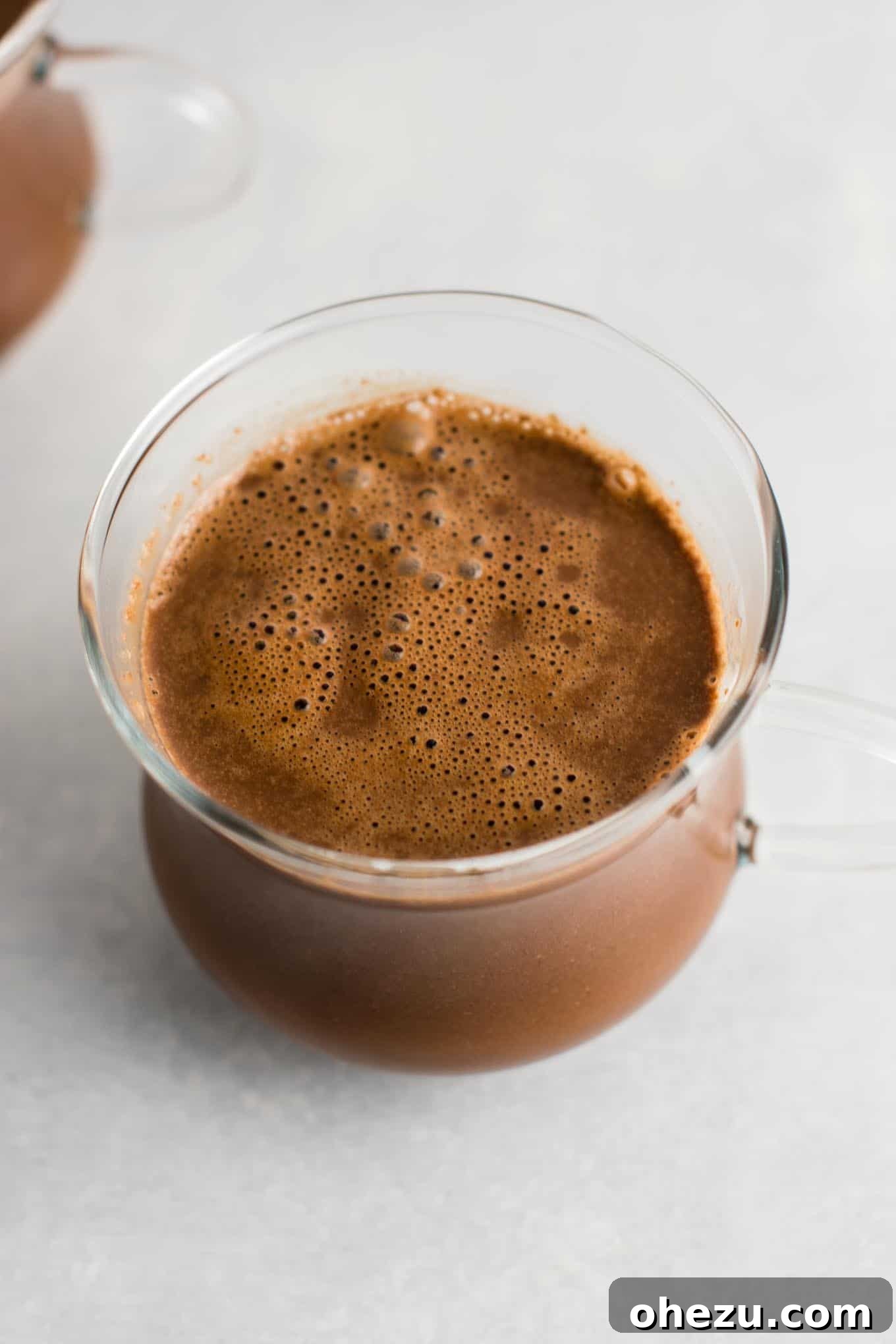 Ingredients for homemade vegan hot chocolate neatly arranged on a white surface, showcasing the simplicity and natural elements of the recipe for a healthy, delicious drink.