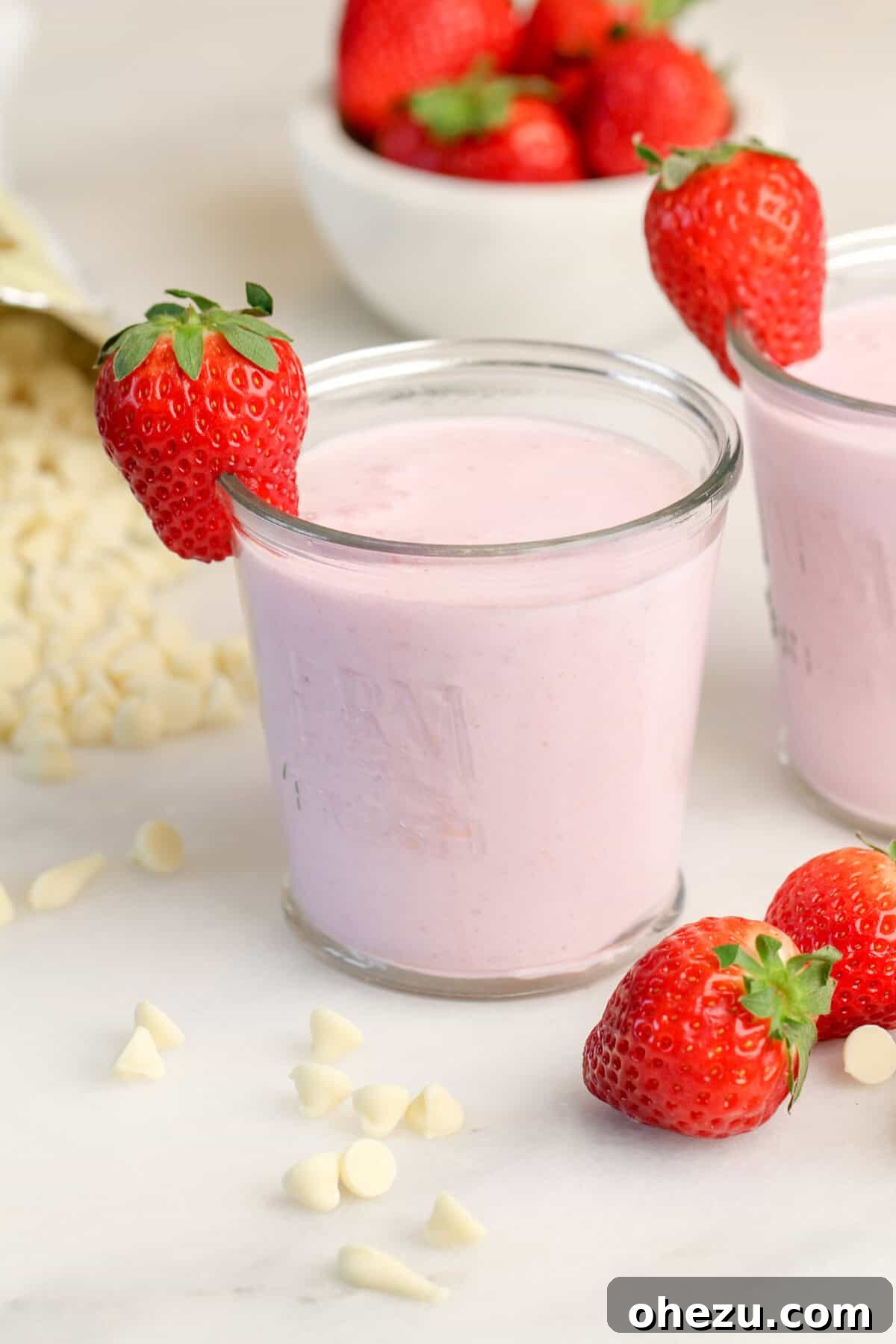 Close-up of a frothy Strawberry White Chocolate Smoothie in a glass, highlighting its creamy texture.