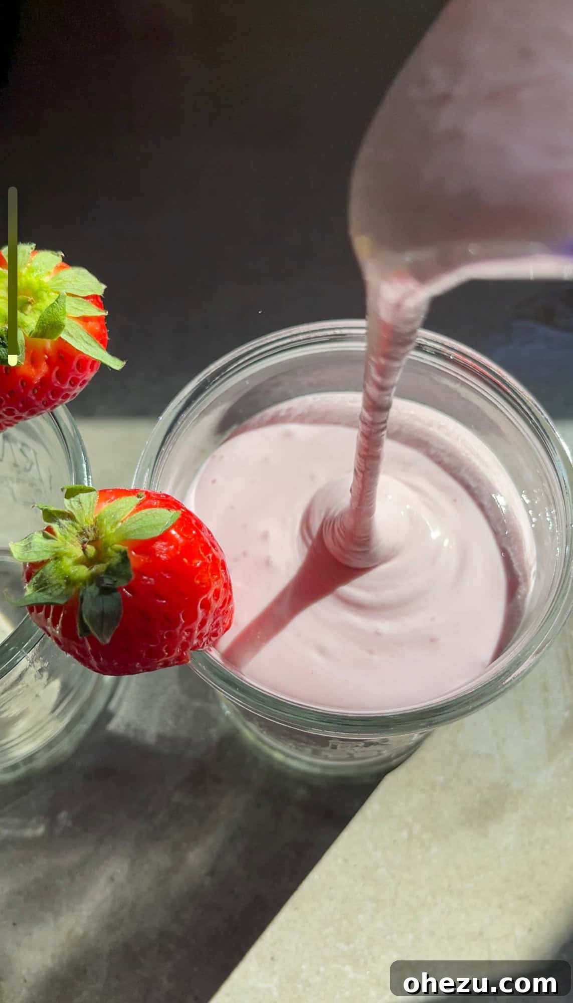 A vibrant Strawberry White Chocolate Smoothie, topped with a fresh strawberry, ready to be served.