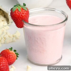 Finished Strawberry White Chocolate Smoothie in a glass with garnish.