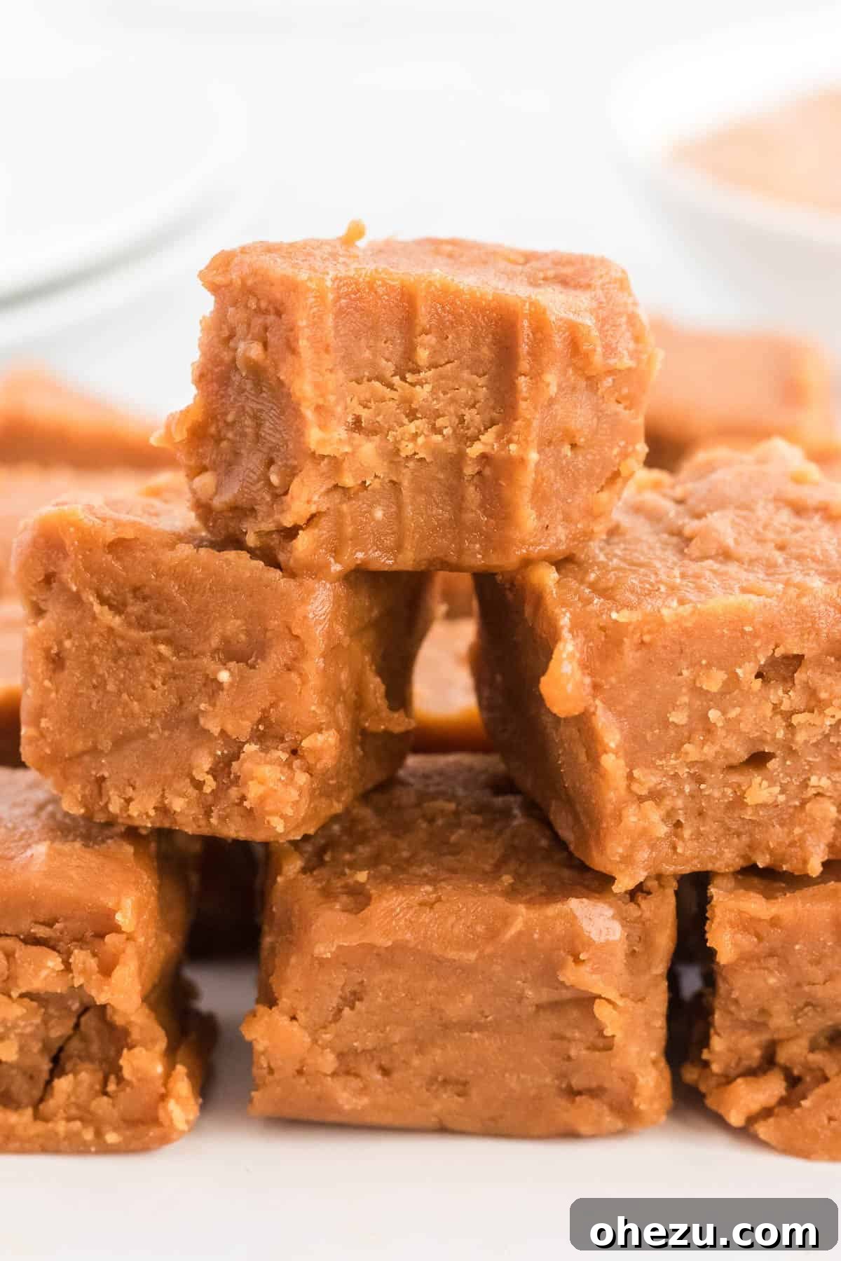 Peanut butter fudge with a bite taken out, showing its creamy texture.