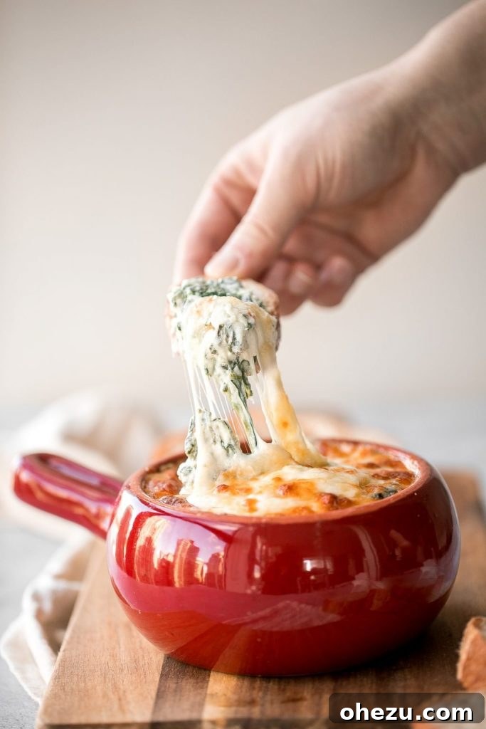 Super Bowl 2022 Your Championship Feast 13 Warm and gooey Cheesy Hot Spinach Dip with tortilla chips, a classic Super Bowl appetizer