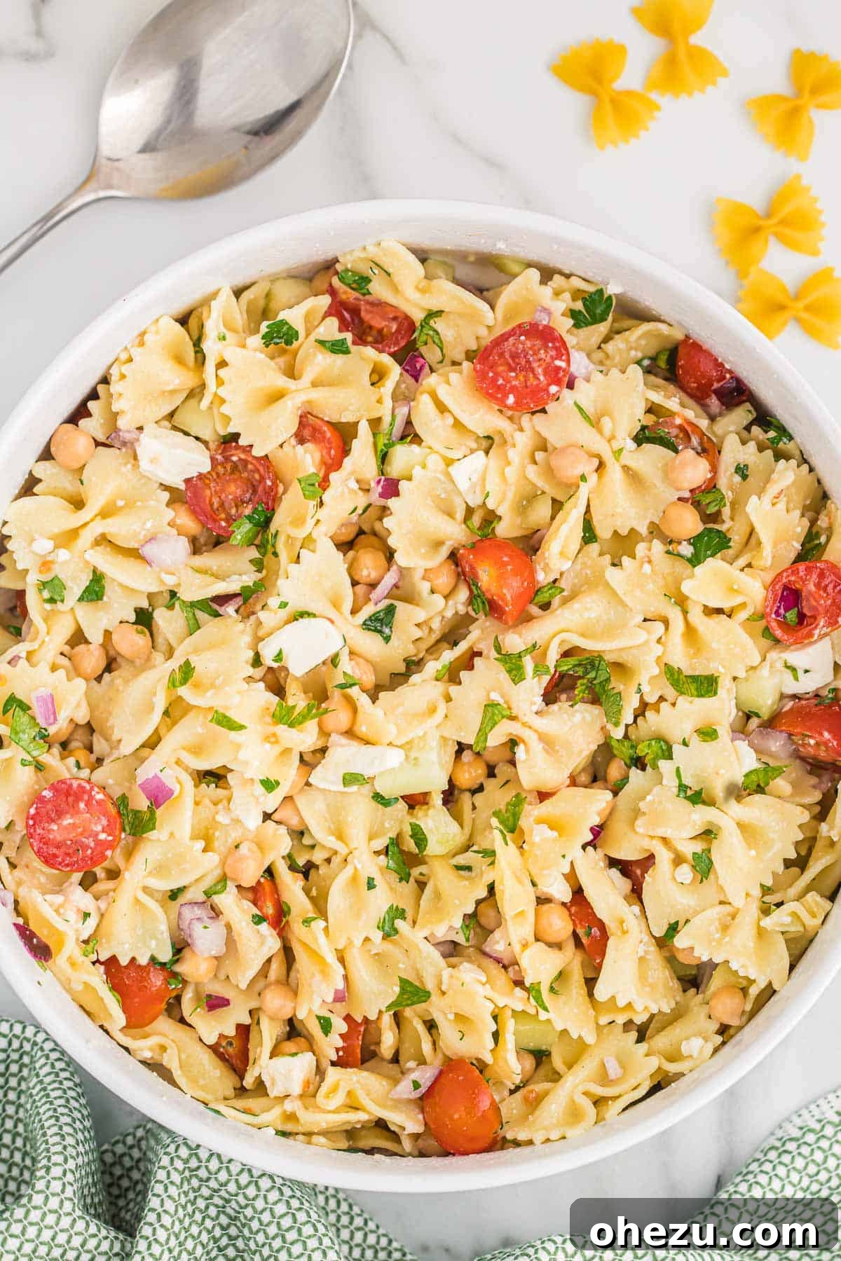 A large bowl of colorful chickpea pasta salad ready to be served