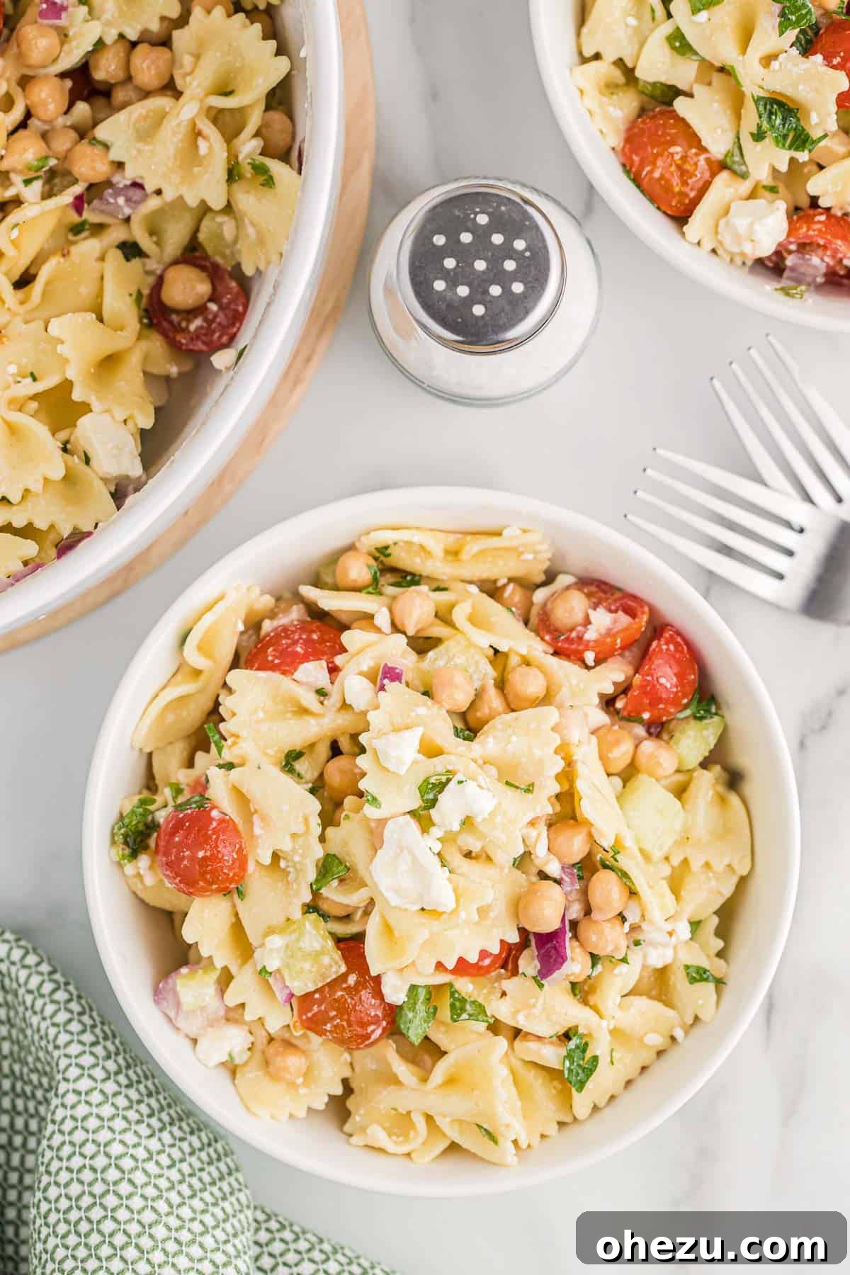 Close-up of a serving of chickpea pasta salad in a small white bowl