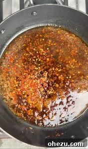 Irresistibly Crispy General Tso's Chicken Recipe 9 General Tso's sauce simmering in a pan