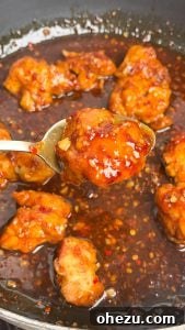 Irresistibly Crispy General Tso's Chicken Recipe 10 Crispy chicken being tossed in General Tso's sauce