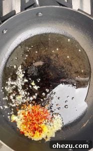 Garlic and ginger sautéing in a pan for General Tso's sauce