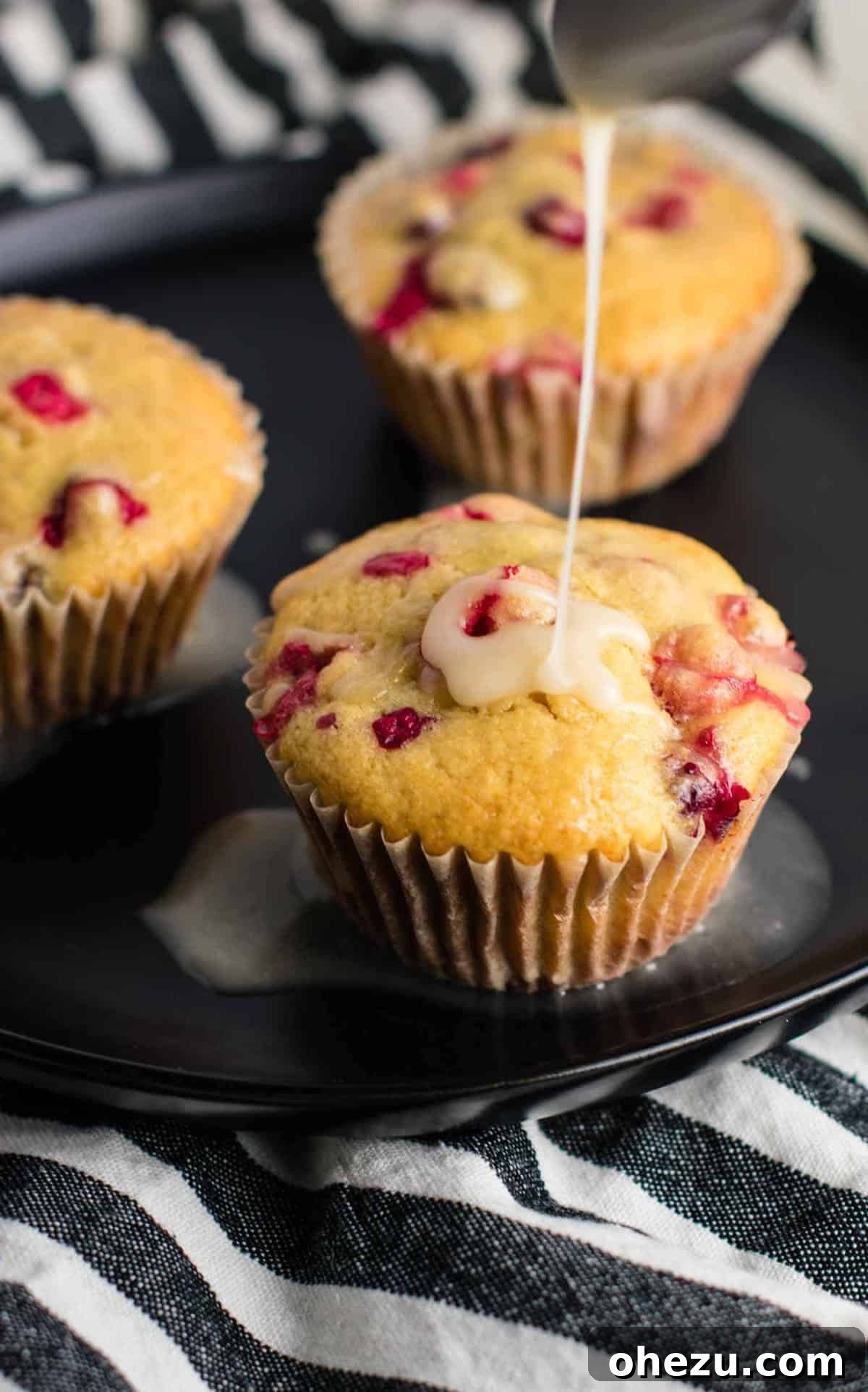 Freshly baked Cranberry Orange Muffins with a sweet orange glaze, perfect for a healthy breakfast or holiday treat.