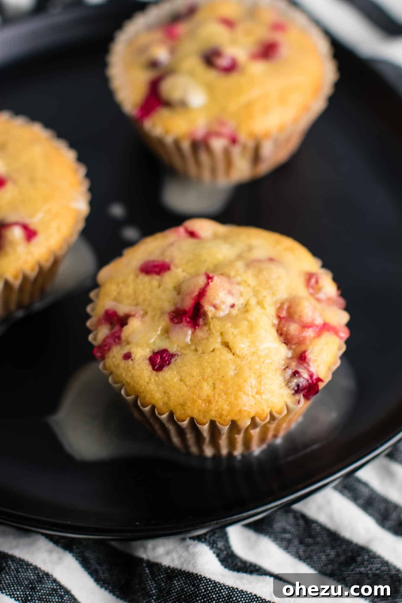 Muffin batter with cranberries being folded in, ready for baking healthy Cranberry Orange Muffins.