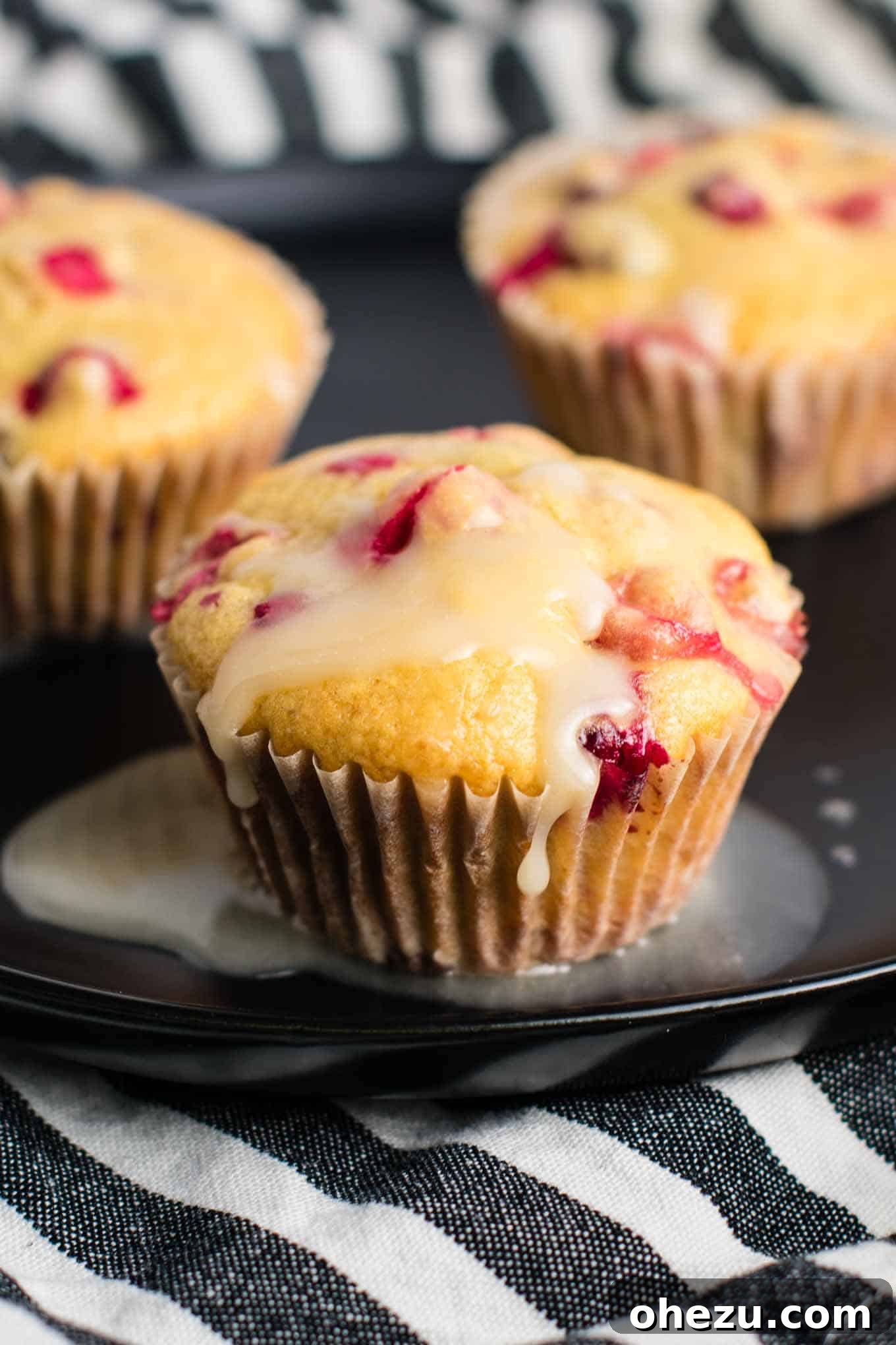 Plate of healthy Cranberry Orange Muffins, glazed and ready to eat for breakfast or a snack.