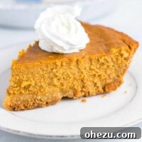 a slice of pumpkin pie on a plate topped with whipped cream