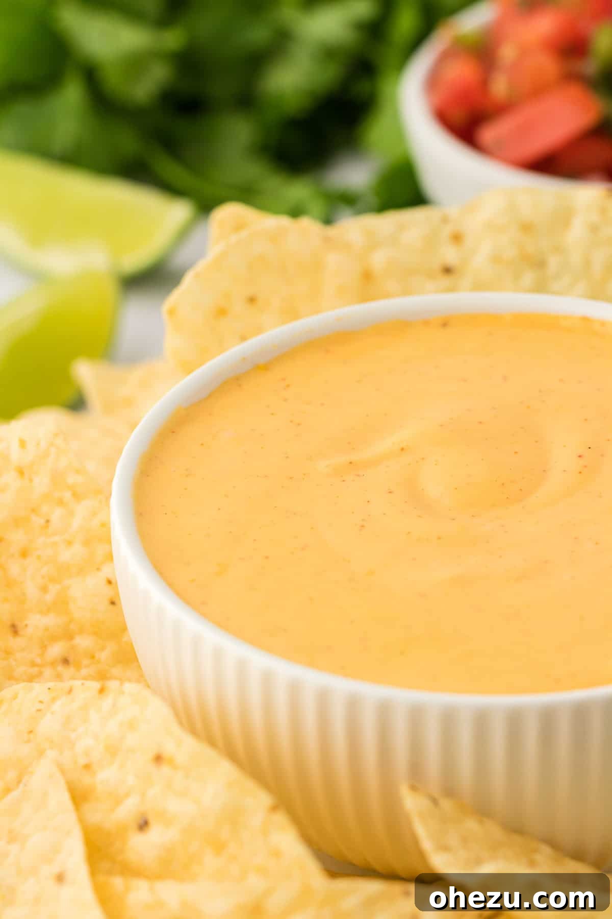 5-Minute Creamy Nacho Cheese Dip 13 A beautifully presented bowl of creamy 5-minute nacho cheese sauce, ready to be enjoyed, with a subtle background blur.